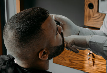 a man getting his hair cut by a barber