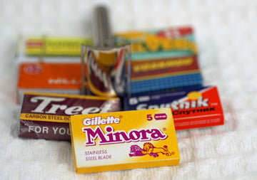Multiple razor blade packages, featuring a yellow gillette minora box.