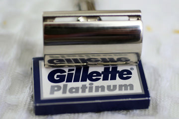 Silver safety razor on a box of gillette platinum blades.
